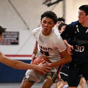 Revere’s Lucca Albano battled Arlington Catholic defenders during recent action. (Advocate file photo)