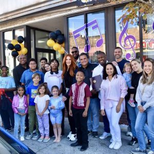 Community members, customers and family gathered together as Mayor Carlo DeMaria cut the ribbon to welcome JC Santos Music School to Everett.