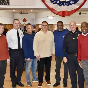 From left: Senator Sal DiDomenico, Fire Chief Joseph Hickey, event organizer and Everett police officer Raoul Goncalves, Mayor Carlo DeMaria, Bishop Robert Brown, Police Chief Paul Strong, and Chelsea City Councillor Calvin Brown.