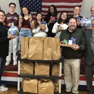 Everett Kiwanis Club President Fred Capone (left) is shown with members of the EHS Key Club as they packed bags of food for Thanksgiving dinners for Everett’s needy families at the Connolly Center. (Courtesy photos)