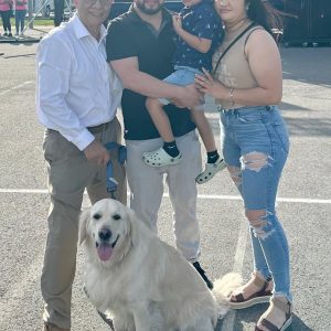 Former Everett City Councillor Al Lattanzi (left) with Liam the Golden Retriever, is shown greeting Antonio Alarcon, owner of Montecristo Ristorante, his son, Ulian and wife, Eva Alarcon at the Fiesta Del Rio that was held at Rivergreen Park on Saturday.