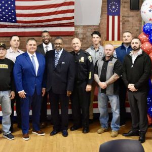 Mayor Carlo DeMaria is shown with Zion Church Ministries Senior Pastor Bishop Robert Brown, Director of Veterans’ Affairs Antoine Coleman, keynote speaker EPD Det. Anthony Cruciotti and members of the Everett police dept. and local veterans.  (Photo courtesy of the City of Everett)