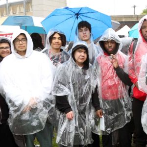 A SOGGY HOMECOMING: EHS students are shown adorned in plastic and carrying umbrellas in the pouring rain at Veterans Memorial Stadium last Friday during the Homecoming event. Many rain-soaked students marched from the high school at approx. 3:30 on a Friday afternoon which caused traffic headaches. Kickoff for the game against BC High wasn’t until 7:00 PM.  (Advocate photo)