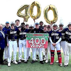 The Malden High Baseball Team and coaches, along with Malden High Director of Athletics, Wellness and Physical Education Charlie Conefrey celebrated the 400-win milestone achieved when Malden topped Everett, 10-0, at Pine Banks Park. (Courtesy Photo/Malden Public Schools Athletics/Katie Bowdridge)