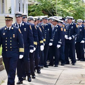 The procession line led by Fire Chief Joseph Hickey as they enter the funeral home.