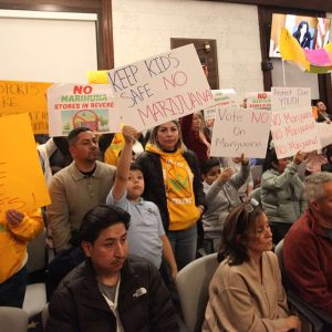 A mass of signs in opposition to retail marijuana shops opening in the city filled the council chamber Monday evening.  (Advocate photo)