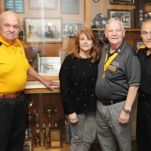 Welcoming Moose International Chairman John Sipes and his wife Linda (center) are Malden Moose Lodge President Ed Strong and Henry Dorazio in front of the showcase of awards presented to the lodge over the years.