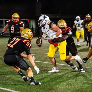 Everett’s Fabrice Michaud tackles a Xaverian ball carrier from behind causing a fumble.