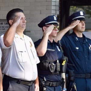 IN SOLEMN REMEMBRANCE: Everett police officers and firefighters are shown saluting during the 9/11 Remembrance Ceremony at Central Fire Station on Wednesday.