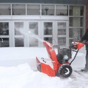 City worker Al Ragucci used the snowblower to clean up the exterior of Everett High School.