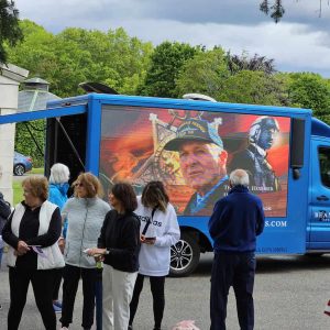 A HERO’S STORY: A special video prepared by Saugus TV Studio Associate John Prudent — displayed on the Beantown Enterprise truck parked at Riverside Cemetery — featured a segment on Medal of Honor recipient Thomas Jerome Hudner, Jr. (Saugus Advocate photo by Mark E. Vogler)