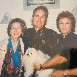 A HOLLYWOOD CONNECTION: A favorite picture from Millie Doucette’s voluminous photo album shows her (left) during a visit with her niece, Pat Woodell, who played Bobbie Jo Bradley in the popular American TV show “Petticoat Junction,” which aired from 1963 to 1970. At center is Woodell’s husband, Vern McDade, holding the pet dog. (Courtesy photo of Millie Doucette)