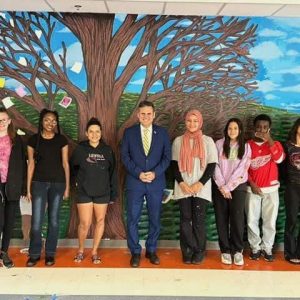 A LIVING GALLERY: Malden Mayor Gary Christenson (center) and Mayor’s Summer Youth Employment Program (MYSEP) supervisor/art teacher Emily Gonzalez (to his left) joined with the youth workers to mark a visually appealing and transformational space at Malden High School’s Cafeteria “A”. (Advocate Photos)