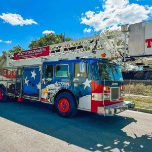 A PATRIOTIC FIRE TRUCK: The “Action” Emergency Management Tower Ladder 1 Truck from Revere is expected to be one of the featured vehicles in Guy Moley’s “Rolling Rally” by Veterans Park next Tuesday, Nov. 11, at the town’s Annual Veterans Day Celebration and Ceremony. (Courtesy photo of Guy Moley to The Saugus Advocate)