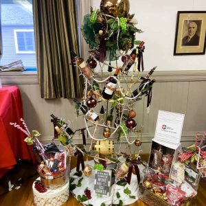 A SAUGUS CHRISTMAS STORY REVEALED: This “Spirit Tree,” decorated with wine bottles, was built by WIN Waste Innovations employees and later entered in the 15th Annual Festival of Trees held at the MEG Building last month. A longtime employee who helped craft the special tree at a time when he was mourning the tragic death of his son found joy in creating the tree. When it came time for the MEG raffle, the grieving dad learned his name was on the winning ticket. (Courtesy photo of Janice K. Jarosz)