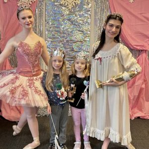 A SPECIAL “NUTCRACKER” TREAT: Twin sisters Claire and Marie Venezia (center), second-graders at the Belmonte STEAM Academy, got to meet ballet dancers Mackenzie Bright (left) and Lila Giamanco (right) last week during a holiday program for kids at the library. (Courtesy photo of Amy Melton)