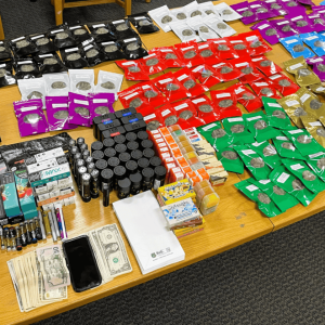 A TABLETOP OF DRUGS: “a substantial amount of marijuana, marijuana-THC products, hallucinogenic mushrooms, drug paraphernalia and hundreds of dollars in cash” taken in a drug bust are on display in the squad room of the Saugus Police Department. (Courtesy Photo of the Saugus Police Department)