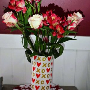 A Valentine’s Day bouquet of roses and Peruvian lilies provides a festive greeting near the kitchen door. (Photo courtesy of Laura Eisener)