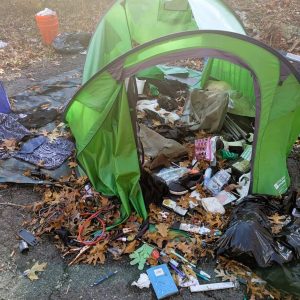 ABANDONED HOMELESS CAMP BEFORE CLEANUP: The area near the tent was littered with trash, including drug paraphernalia and hypodermic needles. (Courtesy photo to The Saugus Advocate)