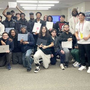 Students in Everett High School’s Programming & Web Development CTE program showcase their newly acquired laptops after completing industry-aligned technology courses through UMass Boston’s ADAGE program, earning professional certifications and hands-on experience with industry experts.