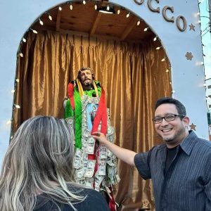 Adam Weldai pinned gelt to the Saint Rocco statue during the 93rd Annual San Rock Festa.