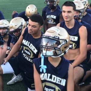 ALL EARS: Malden High captains Mateus Brito and Gabriel Vargas Cardoso, along with sophomore Matthew Candelario Da Costa, listen intently as Coach Witche Exilhomme speaks after practice. (Advocate Photo)