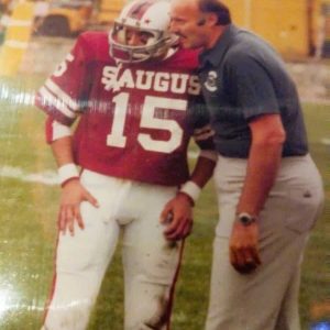 AN INGAME CONVERSATION: Left to right: Then-Saugus High School junior Vincent Serino confers with then-Saugus High School Football Head Coach Mike Ginolfi during a 1983 game. (Courtesy photo of Anthony Cogliano from his High School scrapbook)