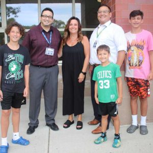 Shown from left to right: Principal Adam Weldai, Assistant Principal Karie Carpenito and Assistant Principal Kenji Foster welcomed sixth-grader Emory, first-grader Paul and seventh-grader Canon Sieswerda, who came from Mystic Valley Regional Charter School.