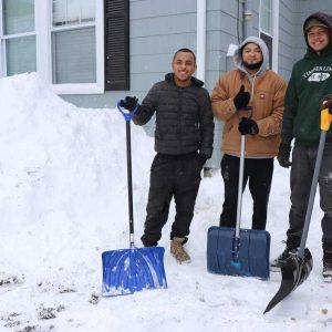 Shown from left to right: After shoveling out their home are Andre Camillo, Maurice Santos and Jonathan Amarao. (Saugus Advocate photo by Tara Vocino)