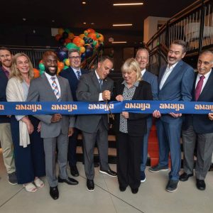 A GRAND OPENING START: Mayor Patrick Keefe is shown cutting the ribbon with Ward 1 Councillor Joanne McKenna during the grand opening of Amaya, the first residential building at Suffolk Downs.  (Courtesy photo)