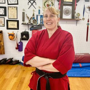 Saugus native Amy Amirault, 6th degree black belt owner of Saugus Tiger Institute Tae Kwon Do in Saugus, demonstrates a high kick and Tae Kwon do moves. (Photo courtesy of Joanie Allbee)