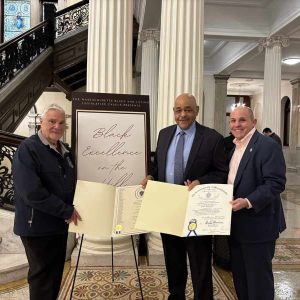 State Representatives Paul Donato (left) and Steve Ultrino are shown presenting Commendations to former Ward 7 Councillor/City Council President Neal Anderson at the State House after he was named a 2025 Black Excellence Award Honoree.