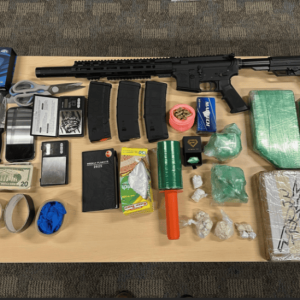 Revere Police displayed an assault rifle, fentanyl, money and other evidence reportedly confiscated during the Dec. 27 arrest at the Quality Inn. (Courtesy of the RPD)