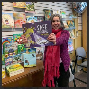 Author Kari Percival holds her book “Safe Crossing.”