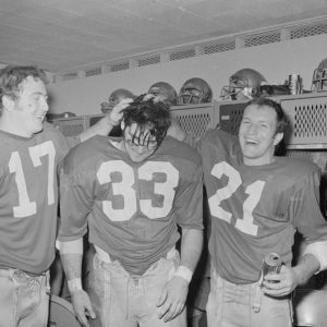 Boston College football players Frank Harris, Fred Willis and George Gill celebrate after a win against Holy Cross.