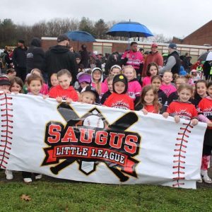 Leading the parade and displaying the banner, shown from left to right: Front row: John Penney, Avery Thomas, Millie Dineen, Emersyn Nichols, Brinley Goncalves, Lucy McKanas, Savannah Kelley and Addi Mason; middle row: Marie and Claire Venezia, Ava Doherty, Elizabeth Arinello, Lettie Blandini and Olivia Howe.