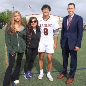 Hailing from Saugus is Matt Banwait who was accompanied by his proud mother, Jennifer, Supt. Alexander Dan, and his sister, Milan during last Thursday’s Mystic Valley Regional Charter School Boys’ Varsity Lacrosse Senior Night against the Watertown High School Raiders. Banwait plans to study computer science at UMass Amherst to enter cyber security. (Advocate photo by Tara Vocino)