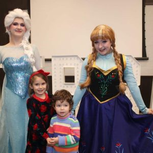 FROZEN FUN: Beachmont Veterans Memorial School preschooler Maivi, 4, second from left, and her brother, Darnel Salla, 2, with Elsa and Princess Anna from Disney’s “Frozen” during the Parks & Recreation Dept.’s Winter Ball on Saturday at the Springhill Suites Ballroom.