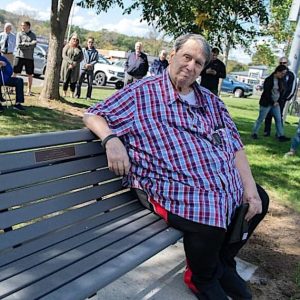 Bob Rotondi sat on the bench dedicated in the name of his sister, Diane Rotondi, at the 2023 dedication ceremony at Pine Banks Park. Bob passed away on June 2 at age 85. (Photo Courtesy Mayor Christenson’s office)