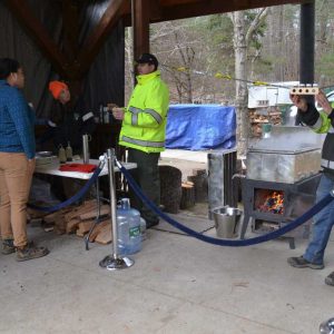 Breakheart Reservation Park Ranger Brett Power (right) showed off varied maple syrup colors as other rangers assisted with the maple sugaring activities on Saturday. (Photo courtesy of Laura Eisener)