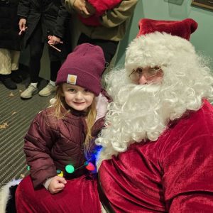 Brielle Doherty, 3, sits with Santa Claus