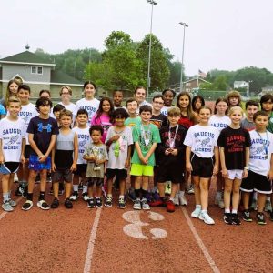 CELEBRATING THE END of this year’s Saugus Sachems Track Camp are several dozen Saugus youths, ranging from four to 18 years old. Holding the second-place trophy from last Saturday’s track meet in Cranston, R.I., is four-year-old Tye Hobbs. (Saugus Advocate photo by Mark E. Vogler)