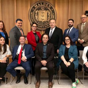 MALDEN CITY COUNCIL: Pictured from left to right: Seated: Jadeane Sica (Ward 8), Chris Simonelli (Ward 7), Carey McDonald (at large), Ari Taylor (Ward 5), Amanda Linehan (Ward 3); standing: Peg Crowe (Ward 1), Craig Spadafora (at large), Karen Colón Hayes (at large), Paul Condon (Ward 2), Ryan O’Malley (Ward 4), Stephen Winslow (City Council President–Ward 6). (Courtesy/City of Malden Photo)