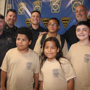 Shown from left to right: In center: Junior Police Academy cadets Lukas Ludwig, Lucien Ludwig, William Hurley and Darrias Reno-Dickerson; standing: Police Officer Matt Cunningham, Police Sgt. David Butler, Police Officer John Uga and Police Sgt. Kenny Kelley.