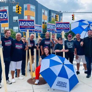 As the summer ends the political season heats up as candidates take their places on street corners to stump with their candidates. Ward 4 Council candidate Paul Argenzio, center, is shown holding signs with supporters at Fenno’s Corner this past weekend.