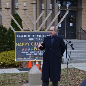 Cantor Craig Mael from Winthrop sang traditional prayers and gave a moving address before the first candle was lit. (Photos courtesy of Laura Eisener)