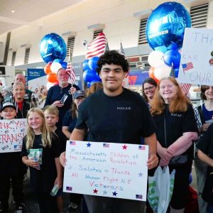 Children of the American Revolution (C.A.R.) greeted the Veterans with colorful handmade signs before their send-off on an Honor Flight. (Courtesy photo to The Saugus Advocate)