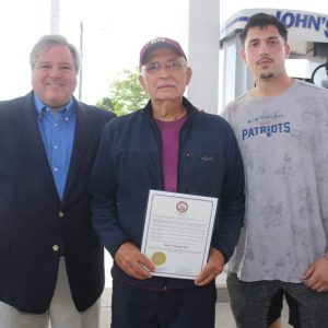 Shown from left to right: mayoral candidate/Councillor-at-Large Daniel Rizzo, John DiLiegro, displaying the citation, and grandson/assistant shop manager Domenic DiLiegro.