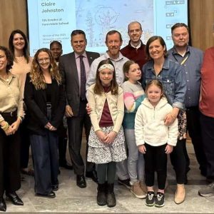 Forestdale K-8 School 5th grader Claire Johnston (center) was honored for the award she received for her sketch “Trees Around the World” in U.S. Rep. Katherine Clark’s 5th Congressional District Art Show Contest. She is shown with Mayor Gary Christenson (to her left back), chairperson of the Malden School Committee, family members, School Committee members, Forestdale School Principal Adam Weldai (far left) and Superintendent of Schools Dr. Timothy Sippel (far right). (Courtesy/Malden Public Schools)