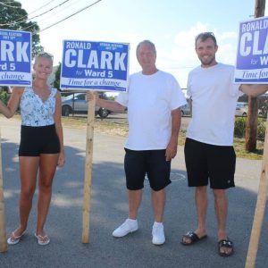Pictured from left to right: his niece Amy Rotger, Ward 5 council candidate Ronald Clark, a newcomer to politics, and his son, Christopher, campaigned for the open seat in front of the Yacht Club on Tuesday.